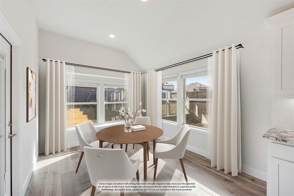 7316 Iris Road Aubrey, TX 76227 - Photo 12 of 40 a view of a dining room with furniture and a window