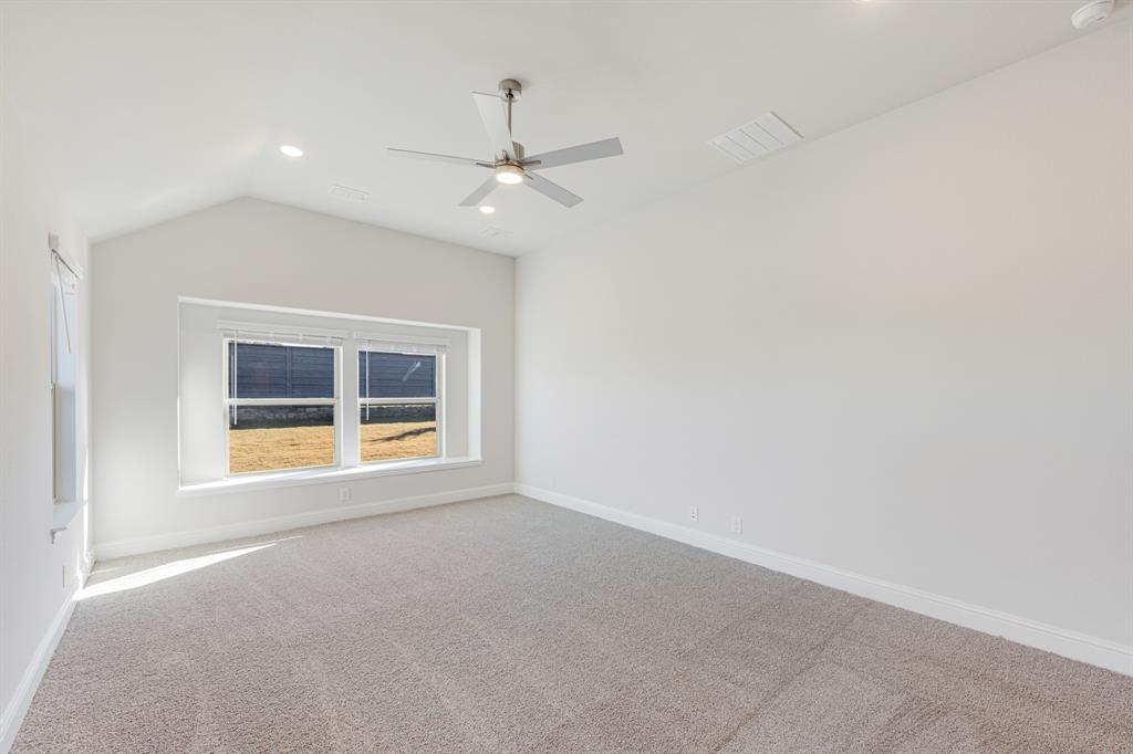 7316 Iris Road Aubrey, TX 76227 - Photo 18 of 40 an empty room with a window and ceiling fan
