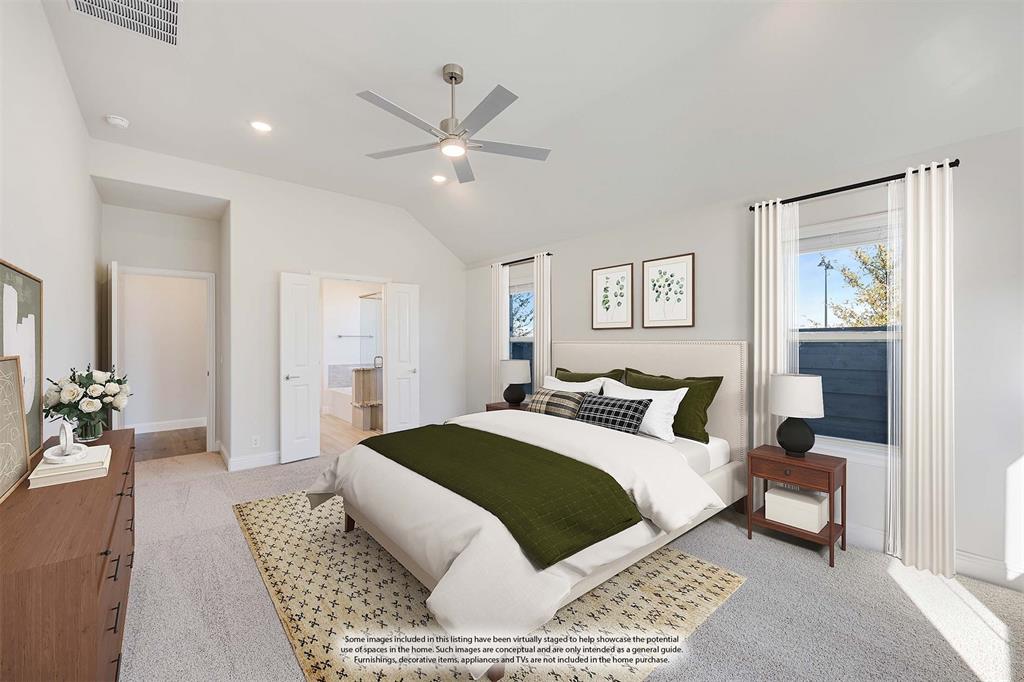 7316 Iris Road Aubrey, TX 76227 - Photo 19 of 40 a bedroom with a large bed and a chandelier