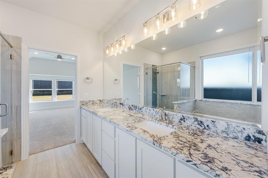 7316 Iris Road Aubrey, TX 76227 - Photo 20 of 40 a bathroom with a sink and a mirror