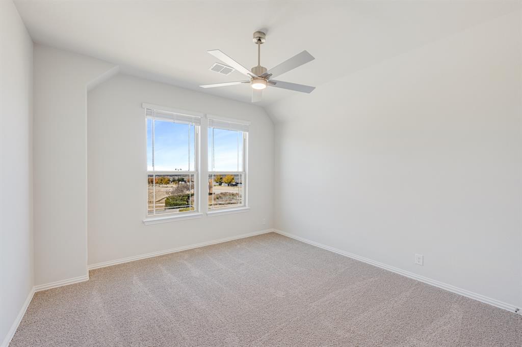 7316 Iris Road Aubrey, TX 76227 - Photo 30 of 40 an empty room with a window and a fan