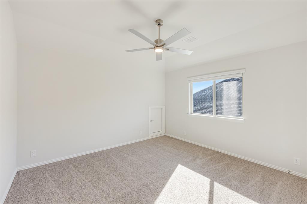 7316 Iris Road Aubrey, TX 76227 - Photo 36 of 40 an empty room with a window and ceiling fan