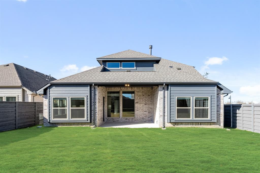 7316 Iris Road Aubrey, TX 76227 - Photo 38 of 40 a front view of a house with a garden