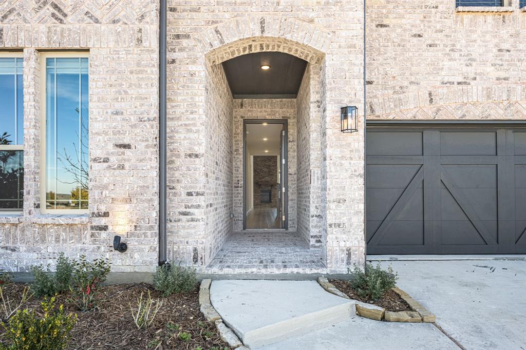 7316 Iris Road Aubrey, TX 76227 - Photo 4 of 40 a front view of a house with a yard