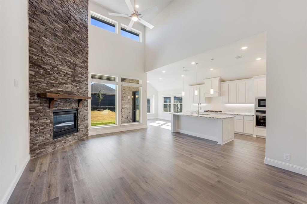7316 Iris Road Aubrey, TX 76227 - Photo 8 of 40 a view of a kitchen with a sink and a stove top oven