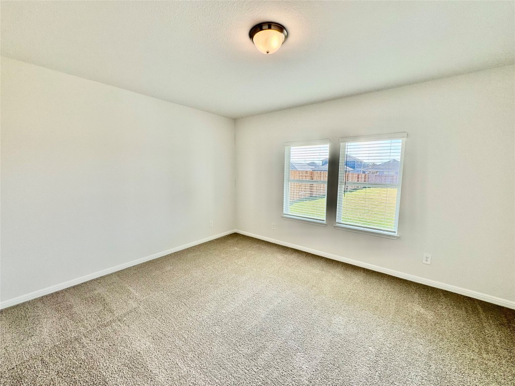 137 Boondoggle Ridge Cedar Creek, TX 78612 - Photo 3 of 7 Carpeted spare room featuring baseboards
