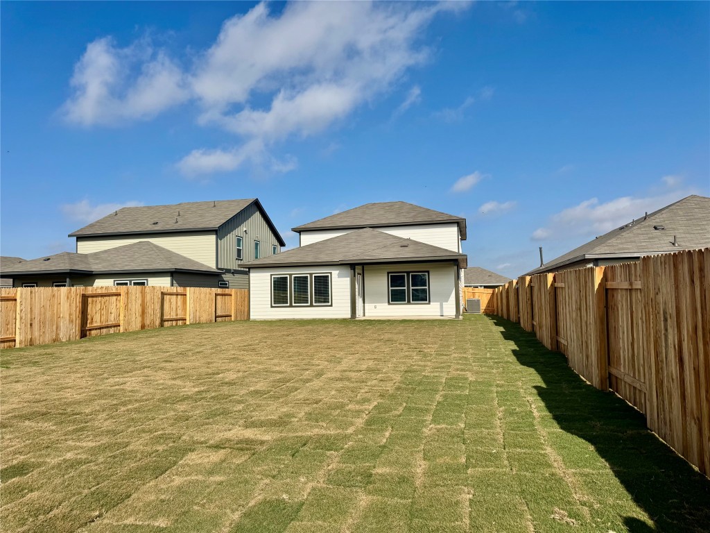137 Boondoggle Ridge Cedar Creek, TX 78612 - Photo 5 of 7 Back of property featuring a fenced backyard and a patio