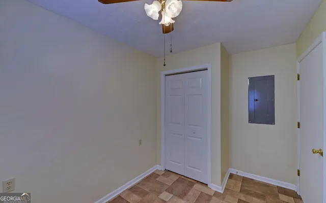 a view of a hallway with a chandelier fan