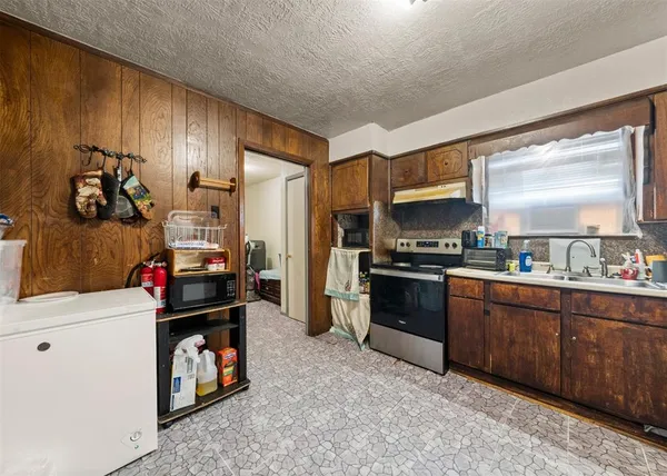 a kitchen with a sink stove and refrigerator