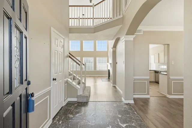 a view of entryway and hall with wooden floor
