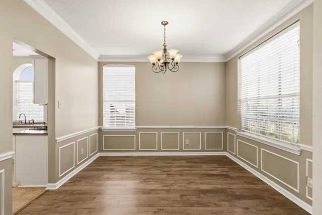 a large kitchen with a sink and cabinets