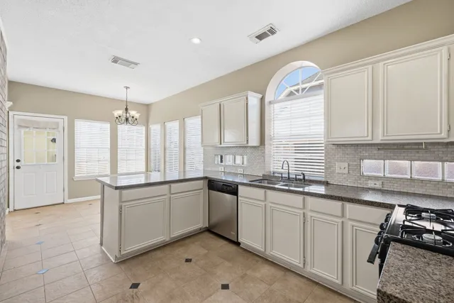 a kitchen with stainless steel appliances a refrigerator and a sink