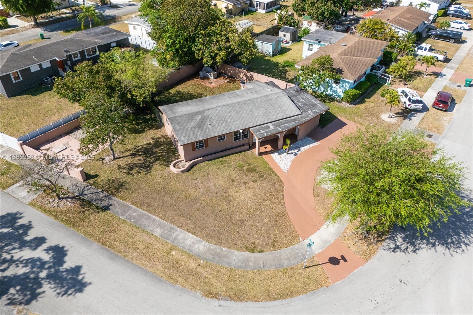 an aerial view of a house with a swimming pool and yard