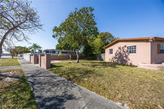 a backyard of a house with large trees