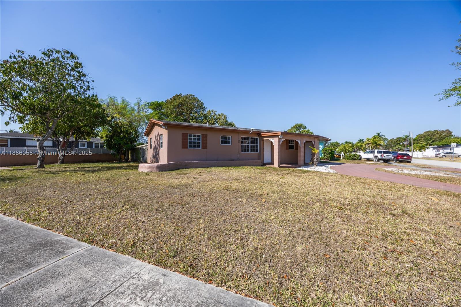 11500 Southwest 142nd Street Miami, FL 33176 - Photo 13 of 35 a front view of a house with a yard