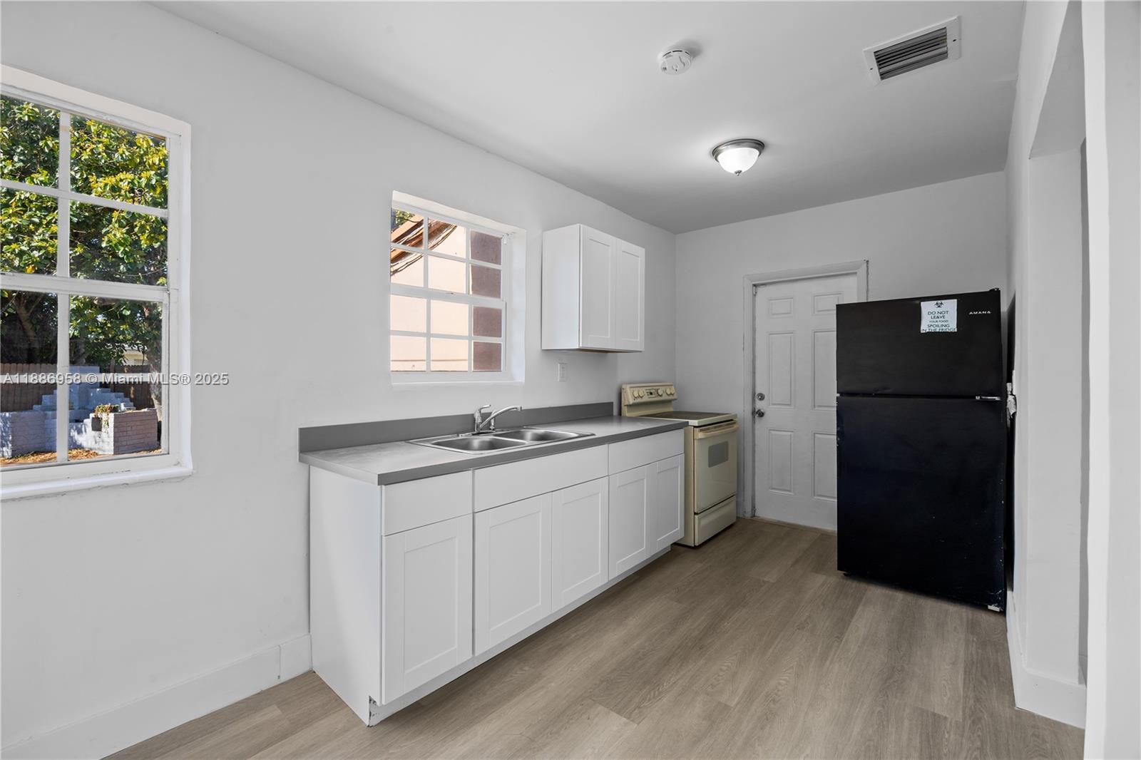 11500 Southwest 142nd Street Miami, FL 33176 - Photo 2 of 35 a kitchen with a refrigerator and a stove top oven