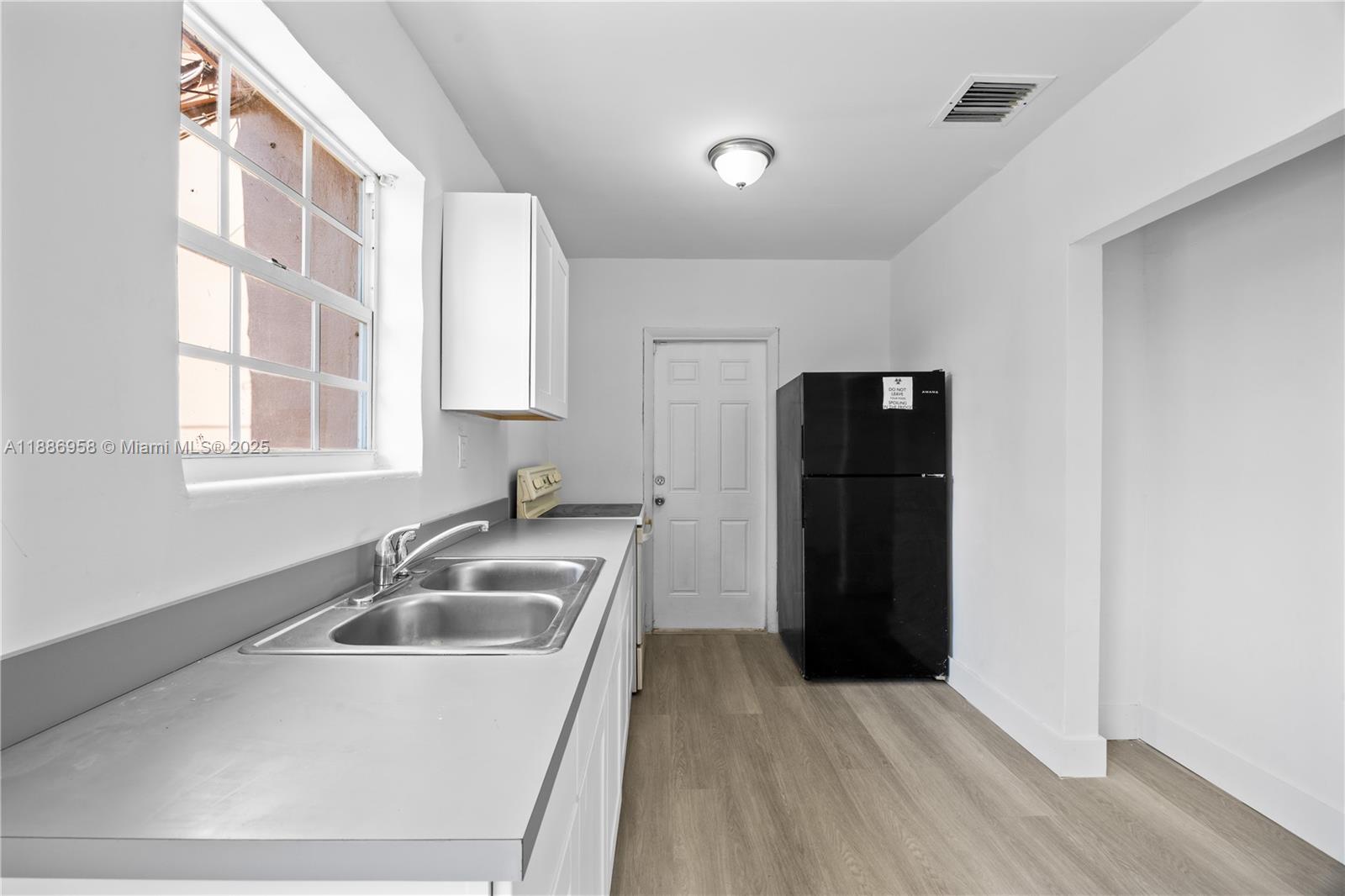 11500 Southwest 142nd Street Miami, FL 33176 - Photo 21 of 35 a kitchen with a sink and refrigerator