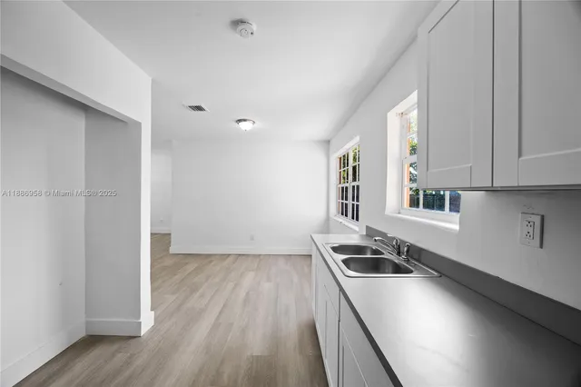 a kitchen that has a sink and a stove in it