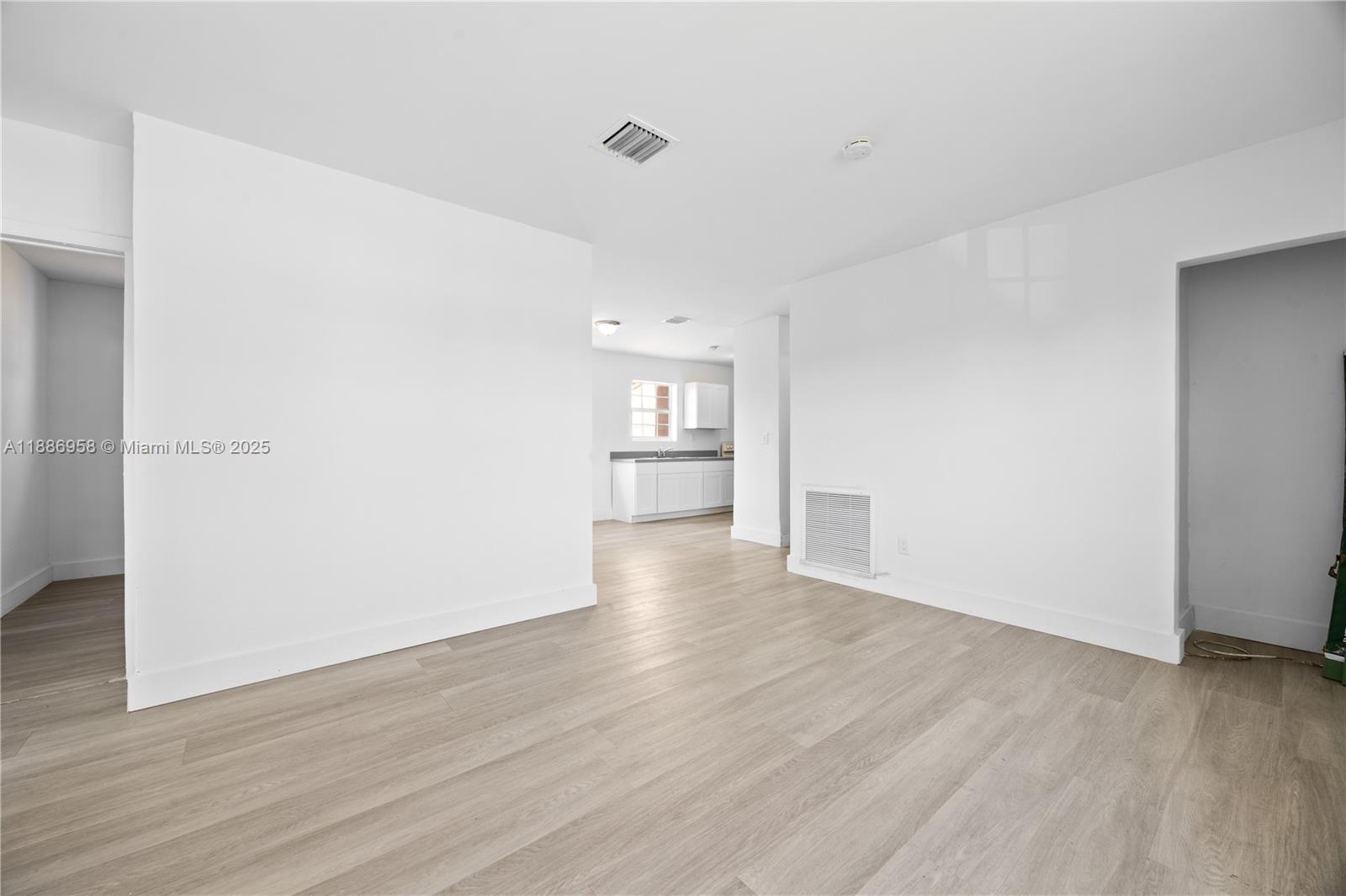 11500 Southwest 142nd Street Miami, FL 33176 - Photo 4 of 35 a view of empty room with wooden floor and kitchen