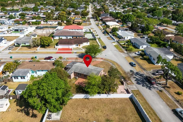 an aerial view of residential houses with outdoor space