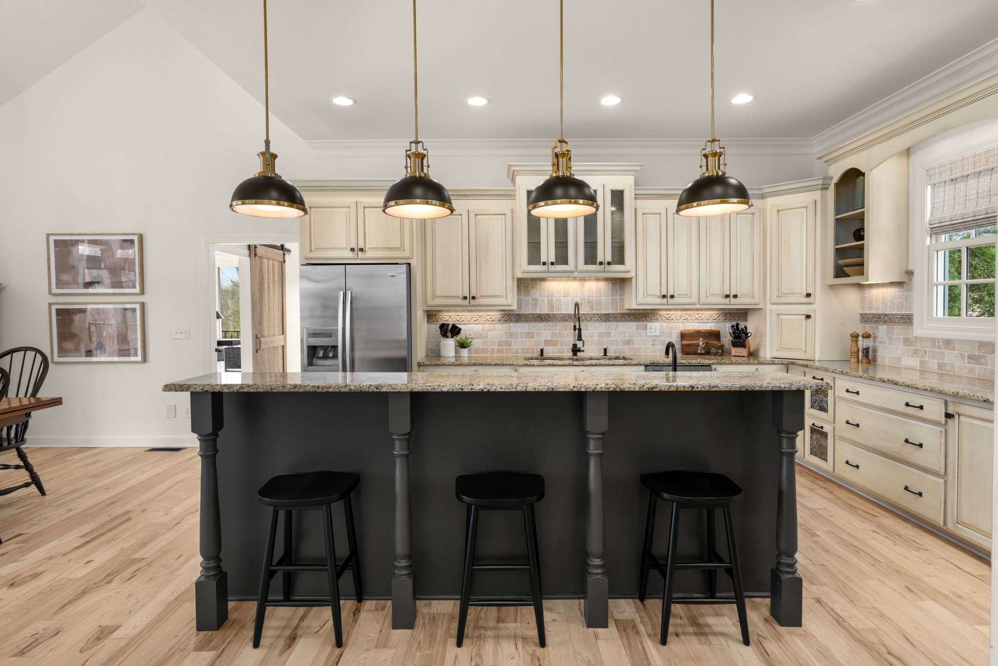7200 Kingston Road Fairview, TN 37062 - Photo 18 of 68 a kitchen with stainless steel appliances kitchen island granite countertop a table chairs sink and cabinets
