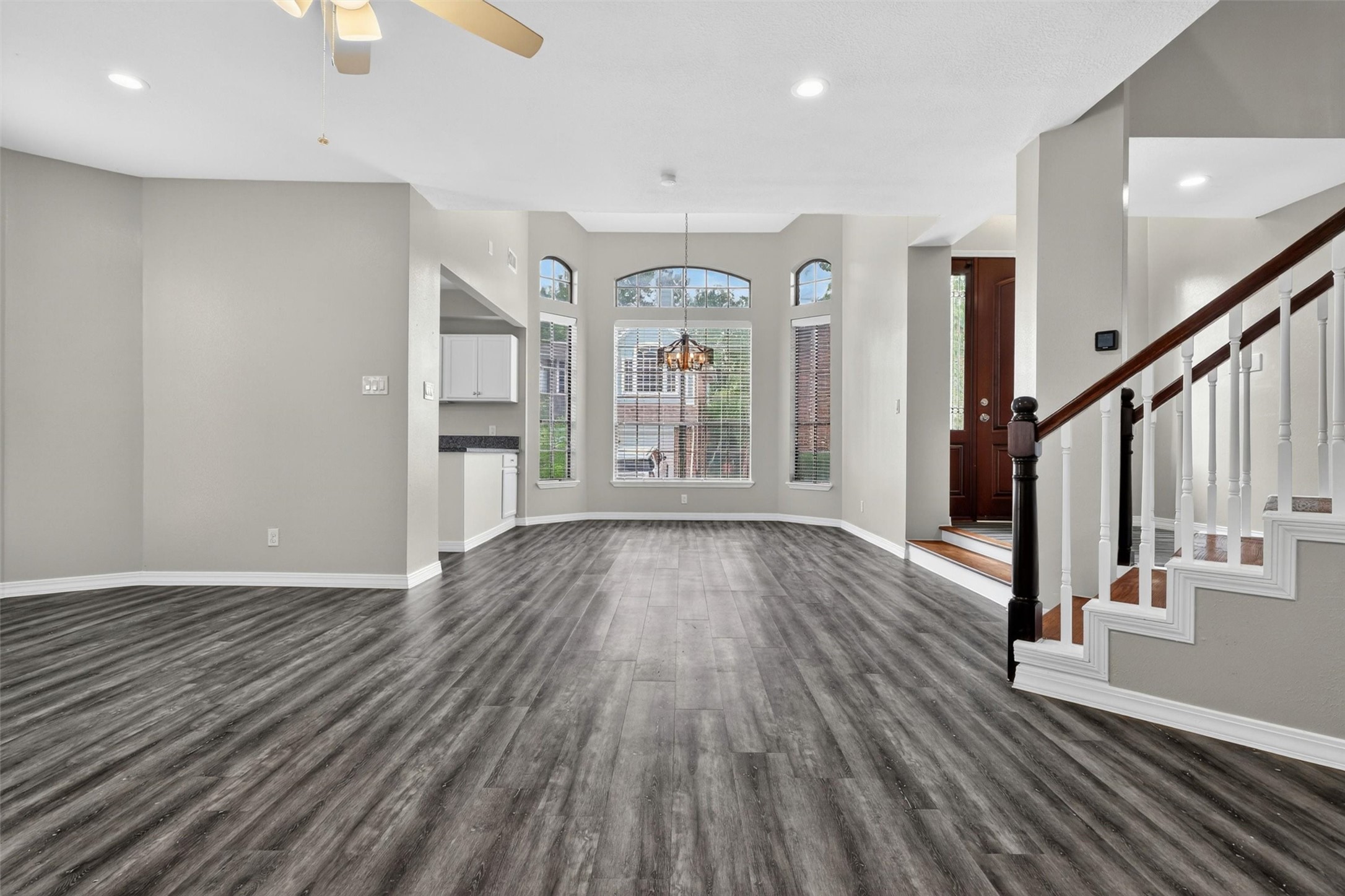 12929 Kingsbridge Lane Houston, TX 77077 - Photo 8 of 42 Step into this spacious and beautifully updated interior featuring soaring ceilings, abundant natural light, and an open-concept design that today’s buyers are searching for. The dramatic entry, elegant staircase, and expansive living area create a grand first impression, while the modern flooring and neutral designer tones offer a fresh, move-in ready feel. Oversized windows enhance the airy atmosphere and bring warmth throughout the home.