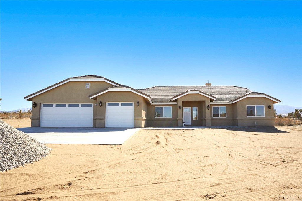 2925 Pinon Road Phelan, CA 92371 - Photo 1 of 1 a front view of a house with a yard covered in snow