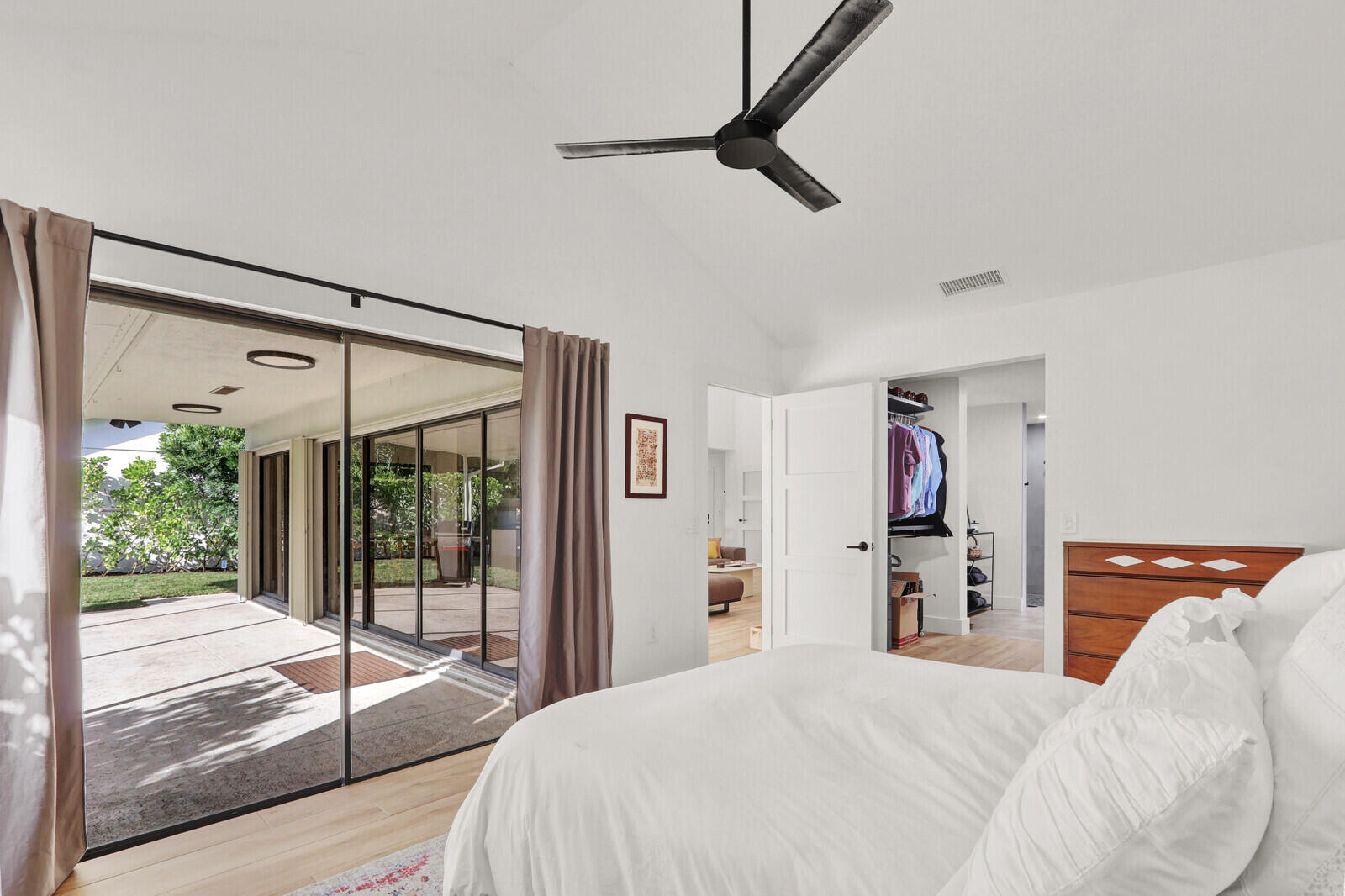 246 Ridge Road Jupiter, FL 33477 - Photo 15 of 39 a bedroom with a bed and a walk in closet