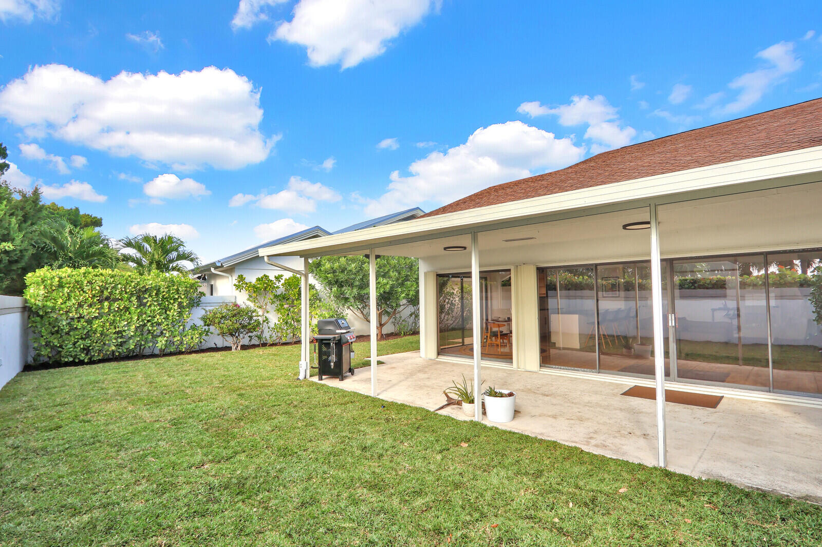 246 Ridge Road Jupiter, FL 33477 - Photo 28 of 39 a view of a house with backyard and porch
