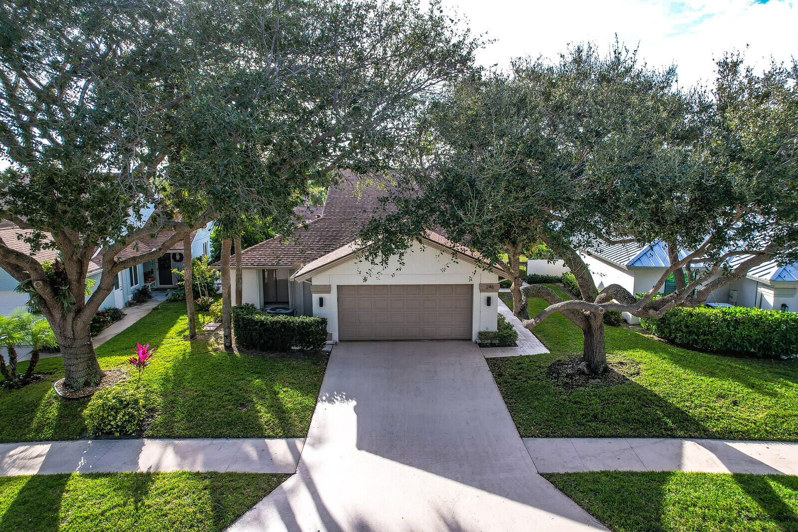 246 Ridge Road Jupiter, FL 33477 - Photo 37 of 39 a front view of a house with a garden and trees