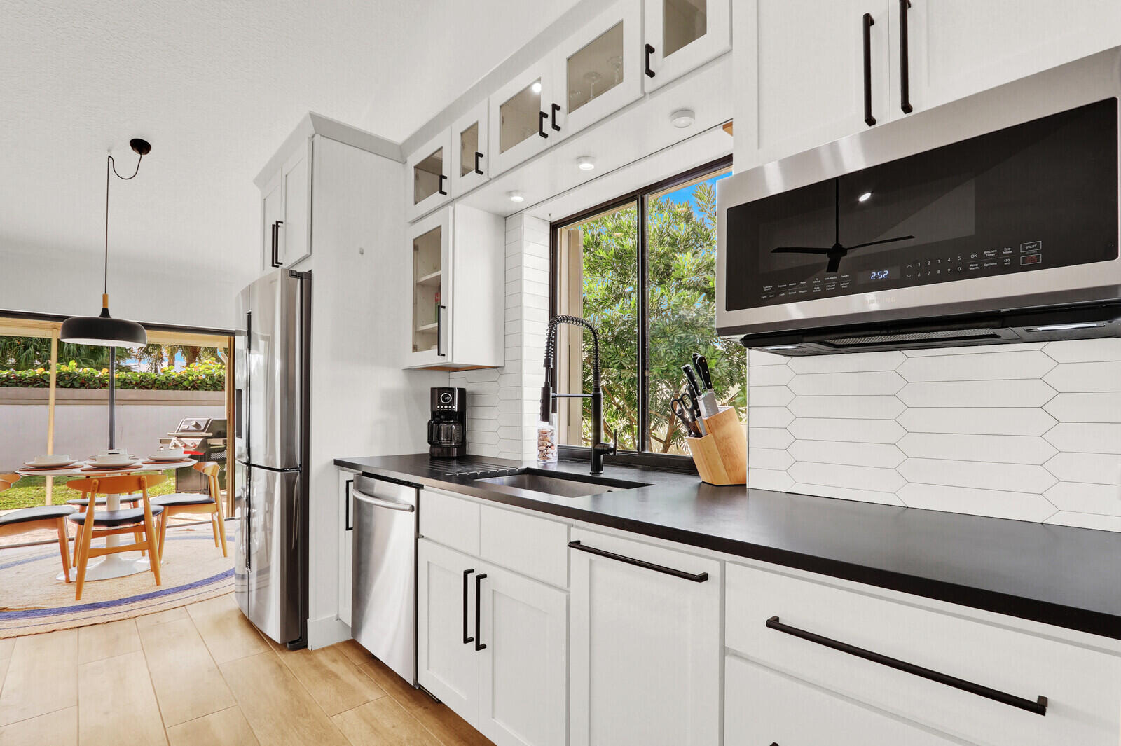 246 Ridge Road Jupiter, FL 33477 - Photo 6 of 39 a kitchen with stainless steel appliances a sink a stove and a refrigerator