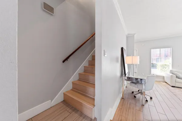 a view of a livingroom with furniture and hardwood floor