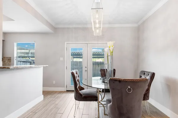 a view of a dining room with furniture wooden floor and chandelier