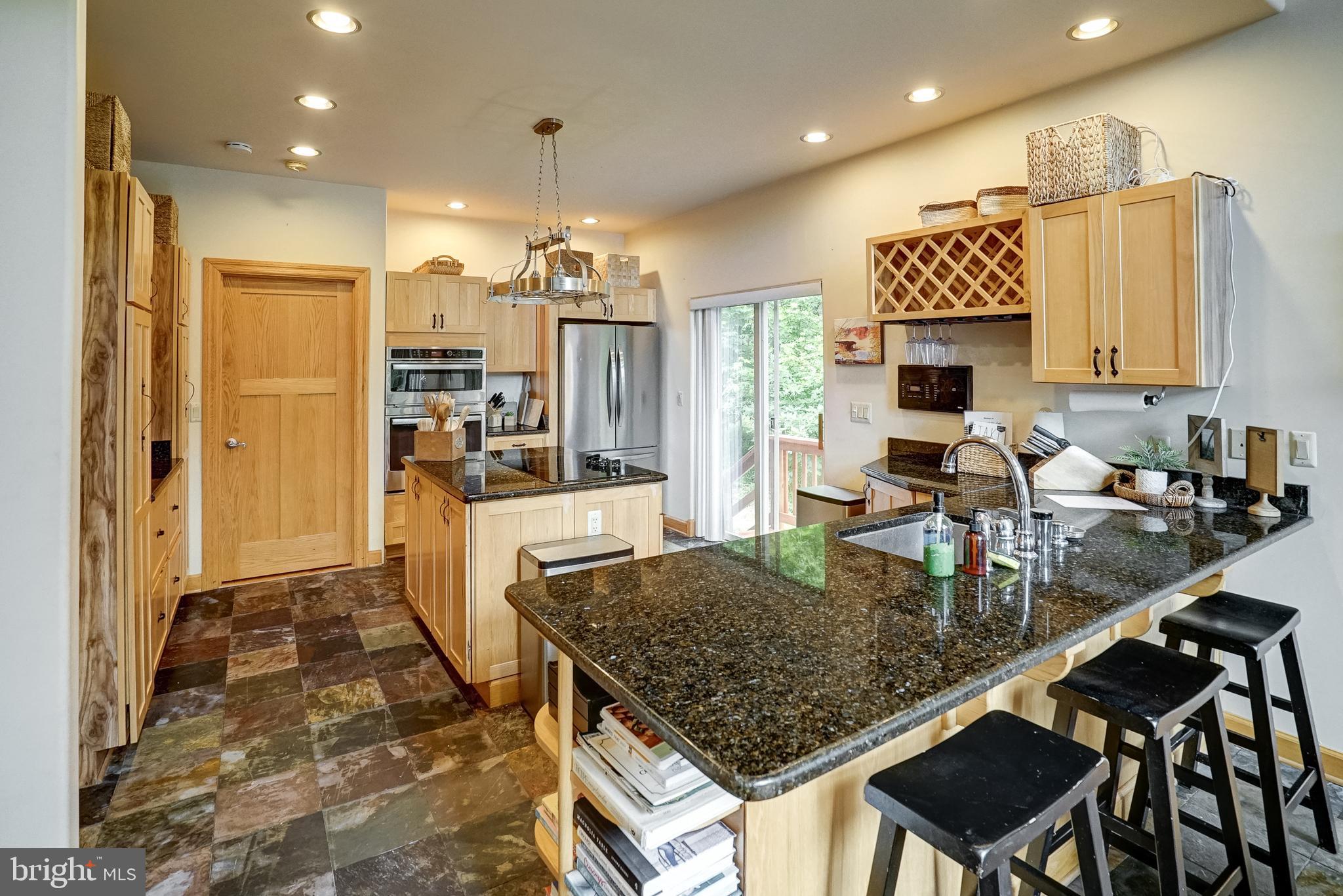 155 Irish Way Bumpass, VA 23024 - Photo 16 of 60 a kitchen with kitchen island a counter top space appliances and a sink