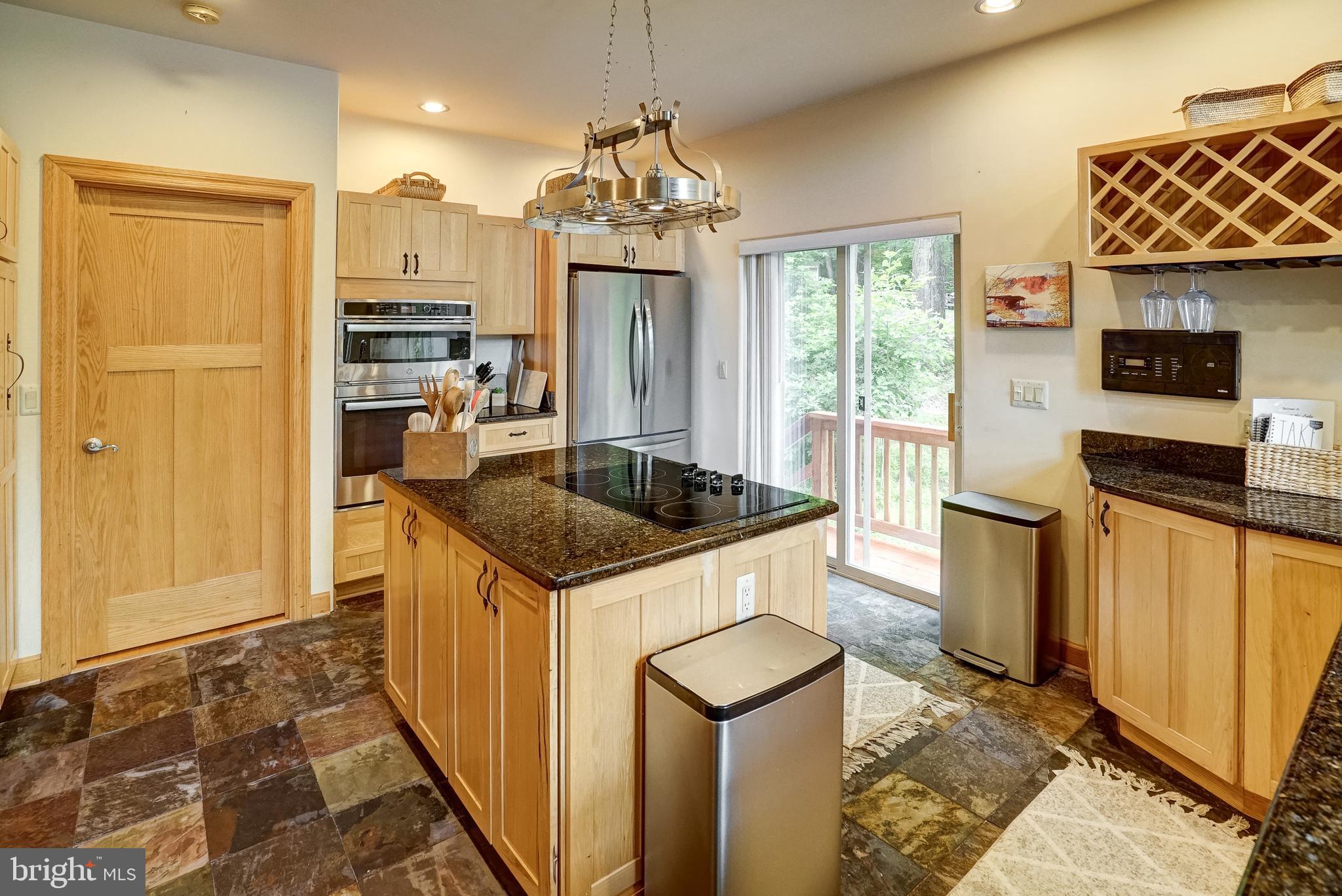 155 Irish Way Bumpass, VA 23024 - Photo 17 of 60 a kitchen with stainless steel appliances granite countertop a refrigerator and a stove top oven