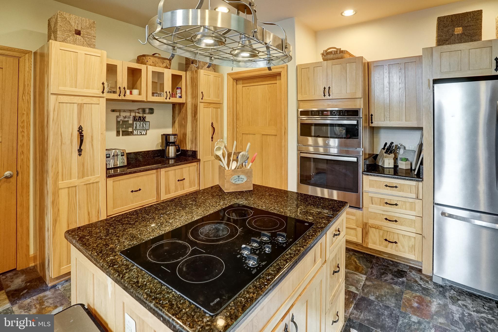 155 Irish Way Bumpass, VA 23024 - Photo 18 of 60 a kitchen with stainless steel appliances granite countertop a stove and a refrigerator