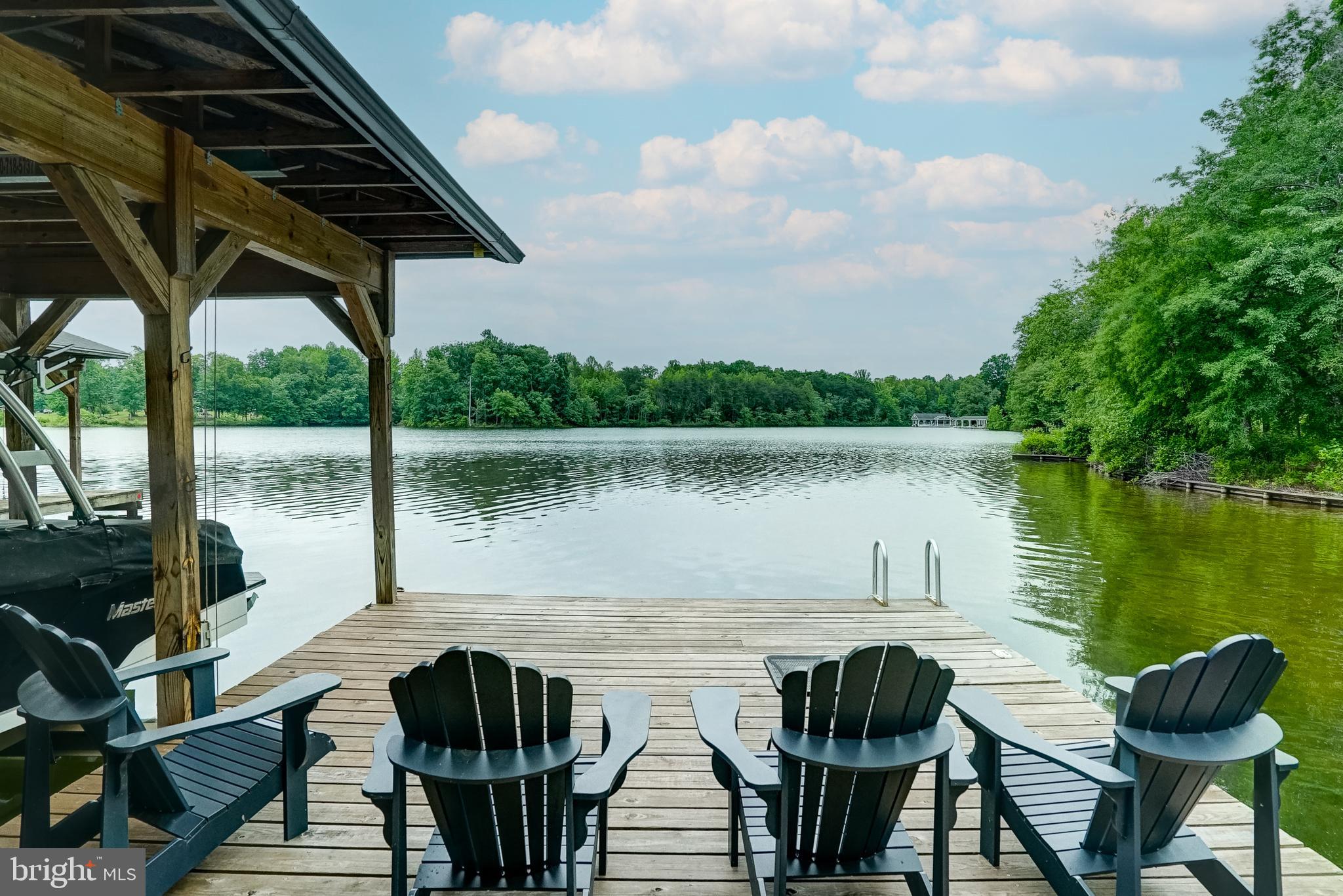 155 Irish Way Bumpass, VA 23024 - Photo 2 of 60 a view of a lake from a balcony with furniture