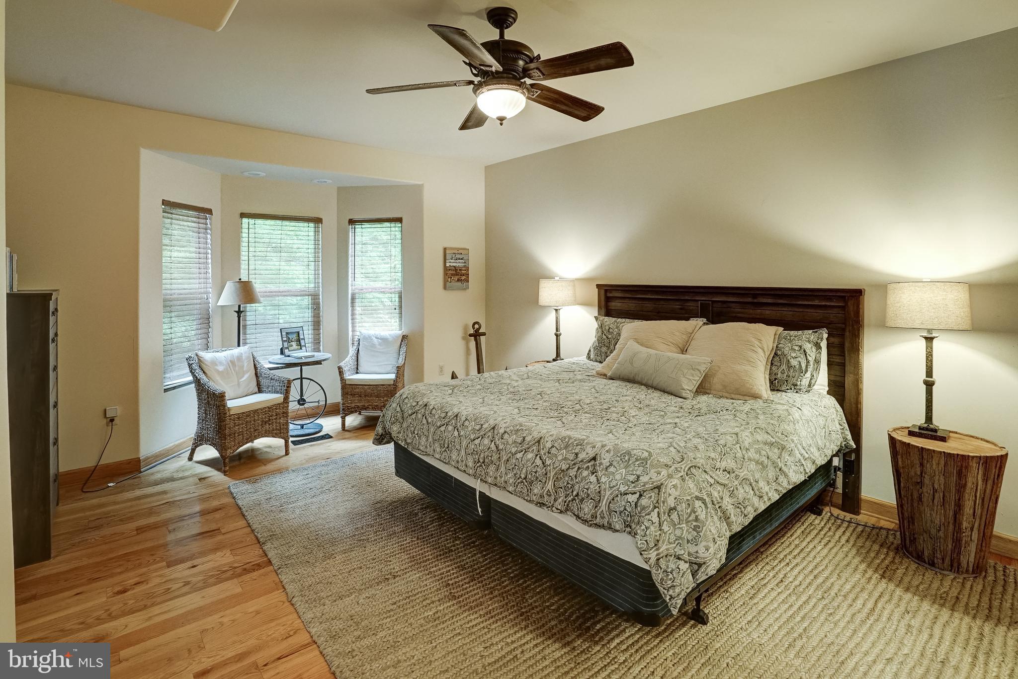 155 Irish Way Bumpass, VA 23024 - Photo 27 of 60 a bedroom with a bed a couch and a chandelier