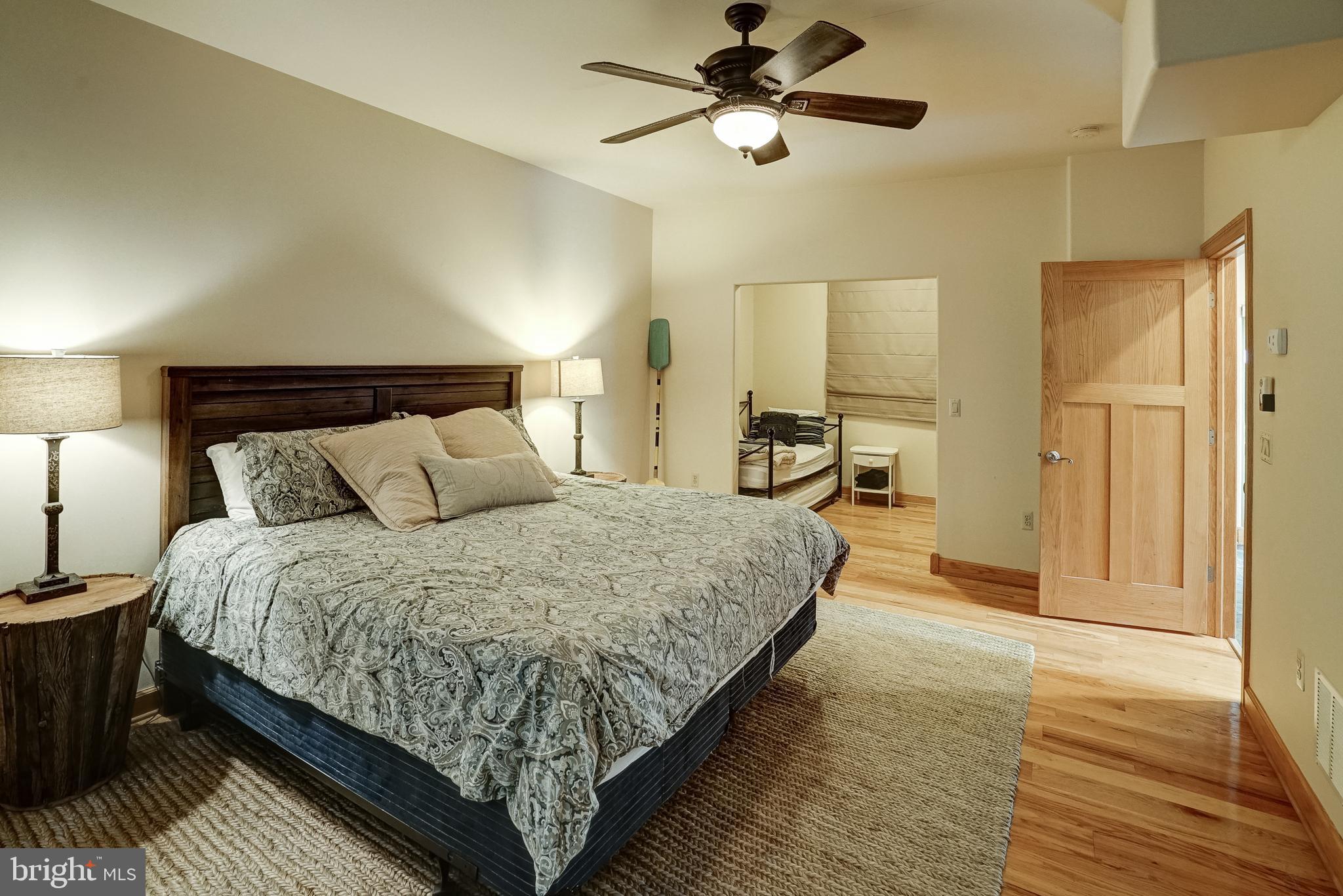 155 Irish Way Bumpass, VA 23024 - Photo 28 of 60 a spacious bedroom with a bed and a chandelier