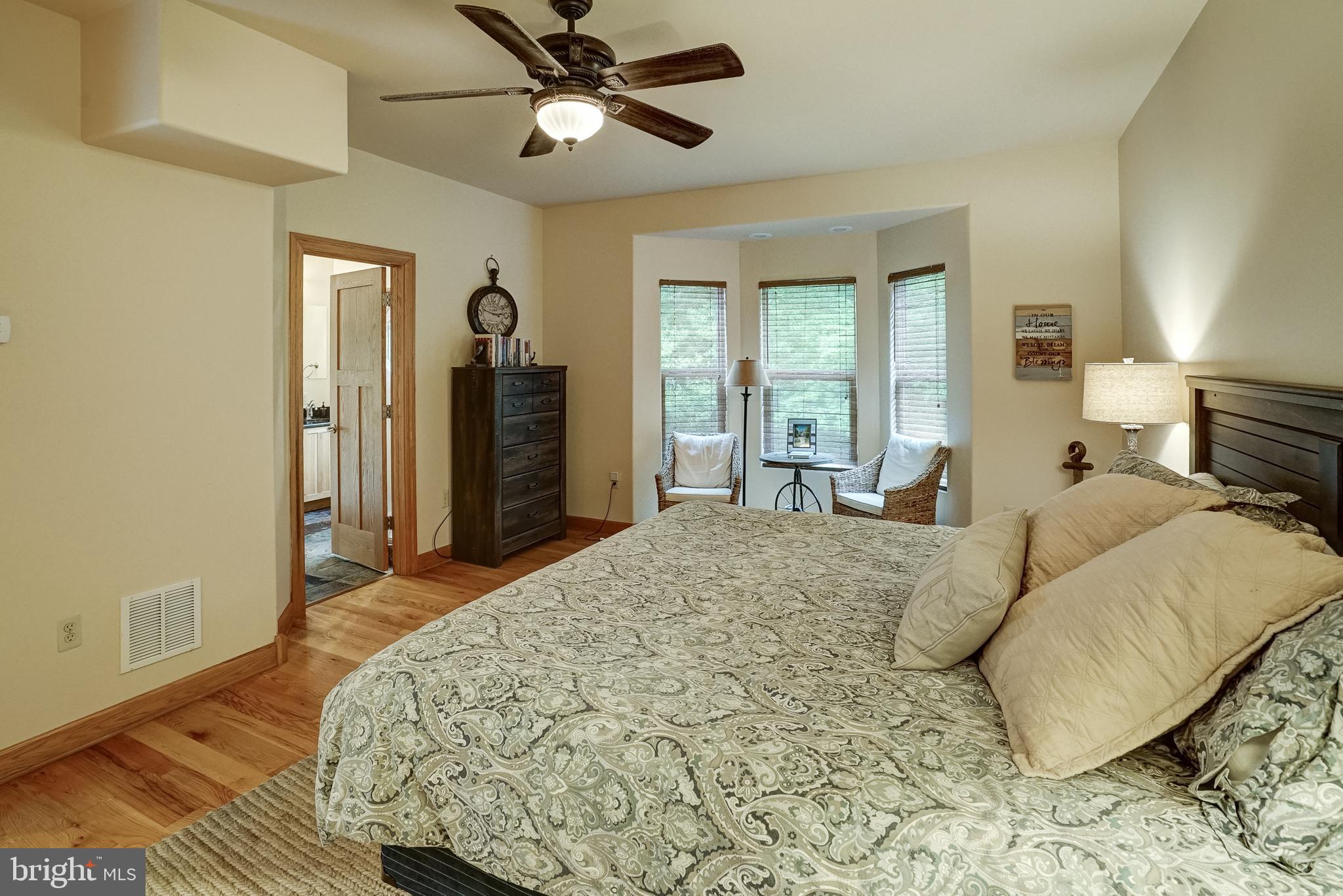 155 Irish Way Bumpass, VA 23024 - Photo 29 of 60 a spacious bedroom with a bed and wooden floor