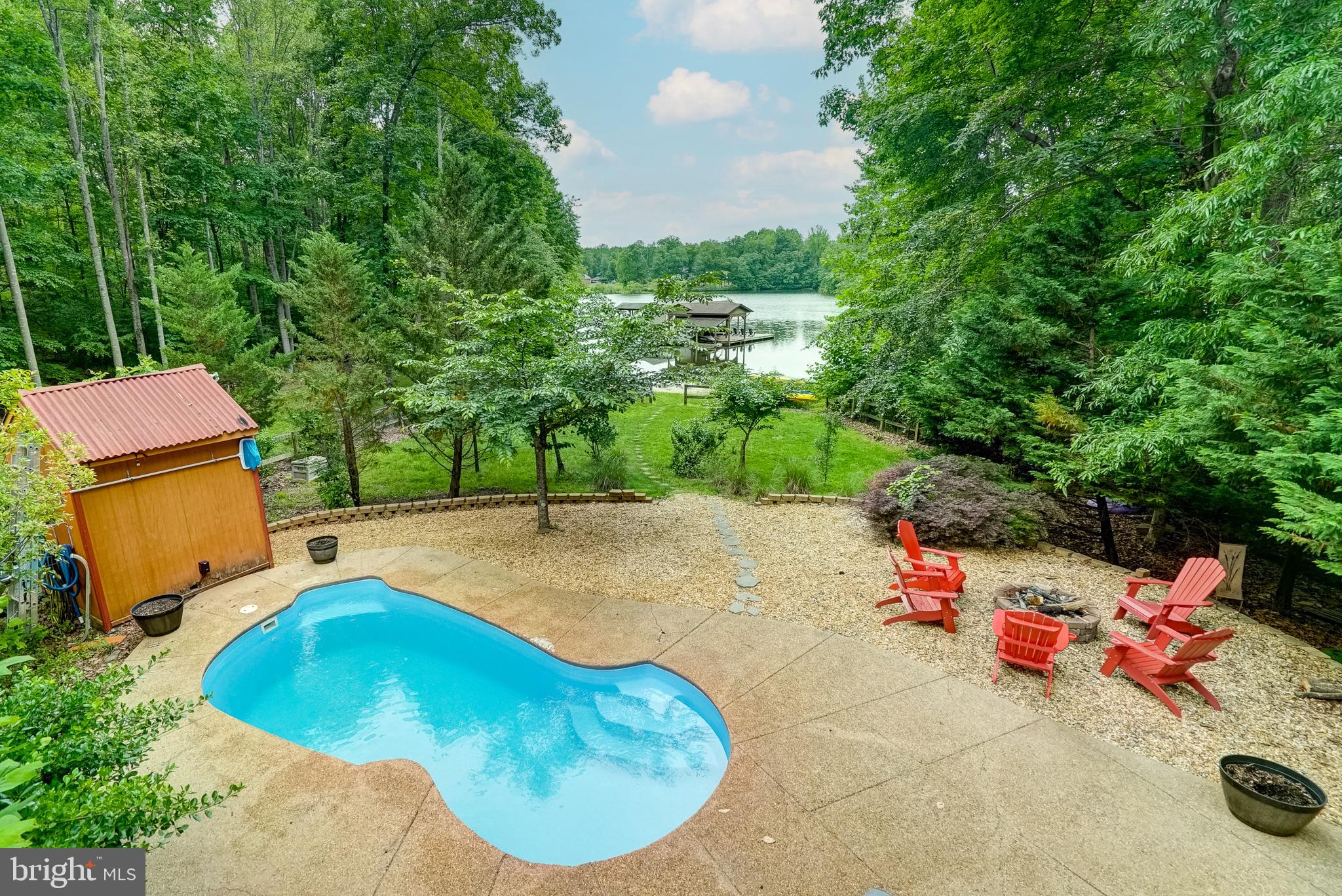155 Irish Way Bumpass, VA 23024 - Photo 52 of 60 a view of a swimming pool with a chairs and plants
