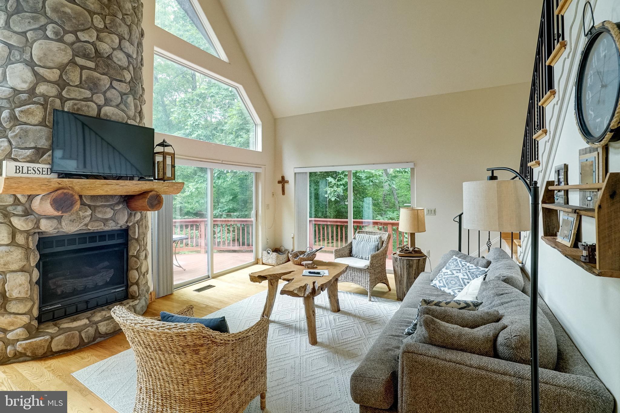 155 Irish Way Bumpass, VA 23024 - Photo 10 of 60 a living room with furniture a fireplace and a floor to ceiling window
