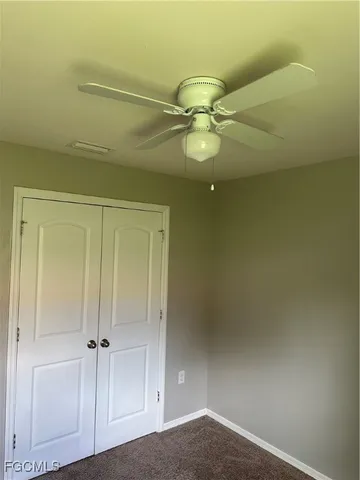a bathroom with a granite countertop sink and toilet