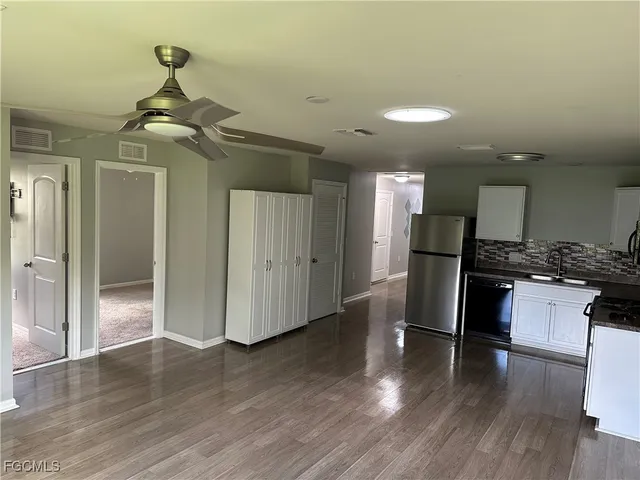 a kitchen with a refrigerator and a stove top oven