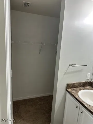 a bathroom with a sink toilet and mirror