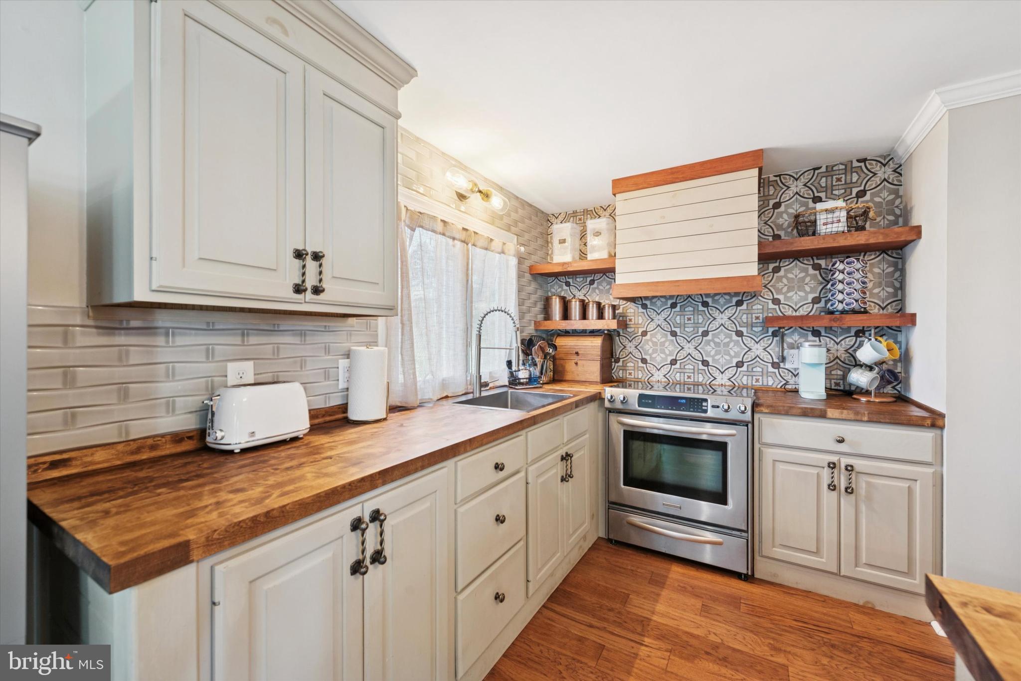1530 Rome Road West Chester, PA 19380 - Photo 7 of 27 a kitchen with stainless steel appliances granite countertop a sink stove and cabinets