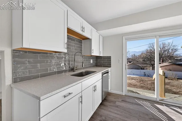 a kitchen with a sink and a stove next to a window