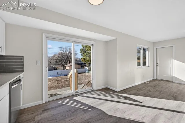 a view of a livingroom with wooden floor and bedroom