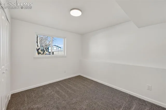 an empty room with a empty space and window