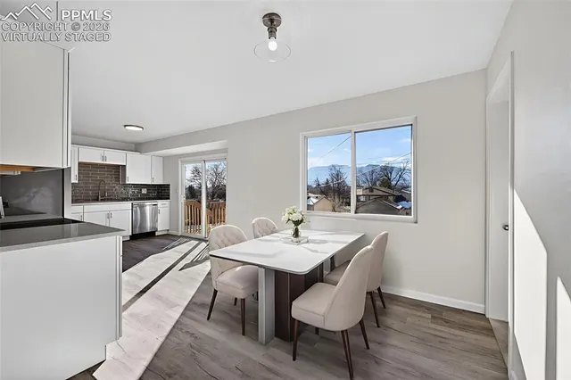 a view of a dining room with furniture and wooden floor